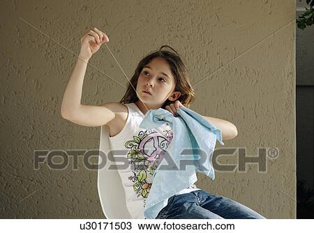 Stock Image - Girl learning to sew. Fotosearch