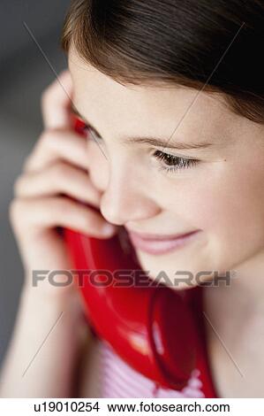 Picture - Girl phoning close-up. Fotosearch