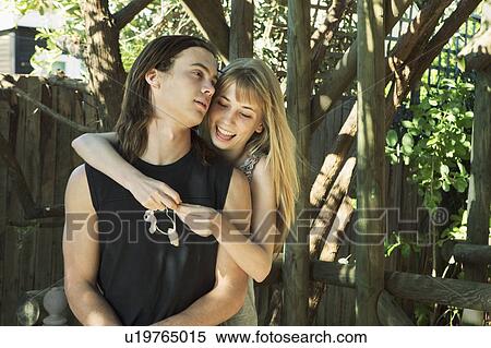 Girl putting shell necklace on young man View Large Photo Image Stock Photography - Girl putting shell necklace on young man. Fotosearch