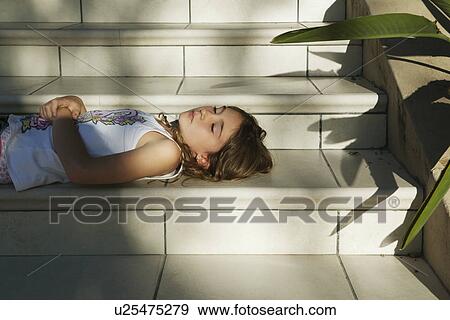 Stock Photo - Girl relaxing on steps. Fotosearch