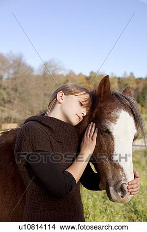 Girl stroking a horse View Large Photo Image Picture - Girl stroking a horse. Fotosearch