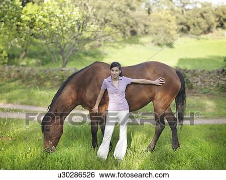 Girl stroking horse View Large Photo Image Stock Photograph - Girl stroking horse. Fotosearch