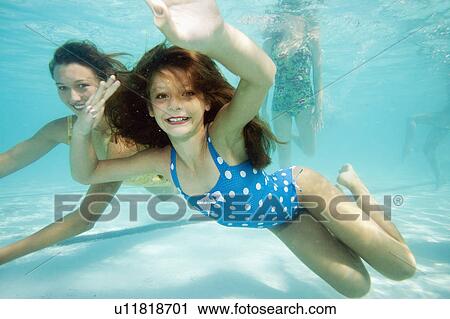 Girl underwater, smiling towards camera View Large Photo Image Stock Image - Girl underwater, smiling towards camera. Fotosearch