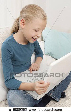 Stock Image - Girl using a laptop. Fotosearch