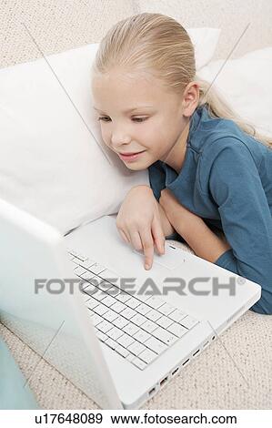 Girl using a laptop View Large Photo Image Stock Photo - Girl using a laptop. Fotosearch