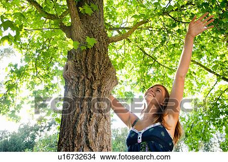 Picture - Girl with a tree. Fotosearch