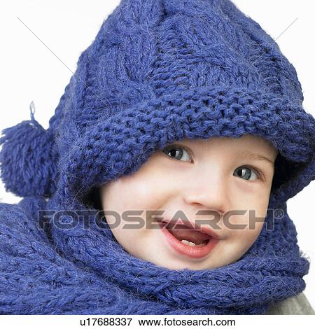 Stock Photo - Girl with hat and scarf, smiling. Fotosearch