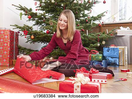 girl wrapping christmas presents View Large Photo Image Picture - girl wrapping christmas presents. Fotosearch