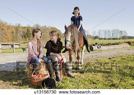 Girls at a stable View Large Photo Image Stock Image - Girls at a stable. Fotosearch
