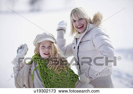 Girls doing a snowball fight View Large Photo Image Stock Image - Girls doing a snowball fight. Fotosearch