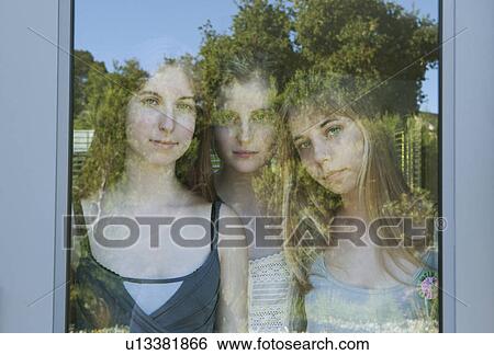 Girls looking through glass door View Large Photo Image Stock Photograph - Girls looking through glass door. Fotosearch