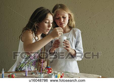 Stock Photograph - Girls mixing paint together. Fotosearch