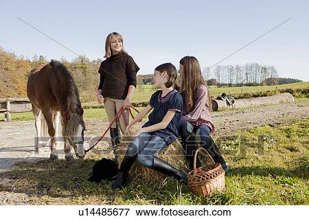 Stock Photo - Girls with horse. Fotosearch