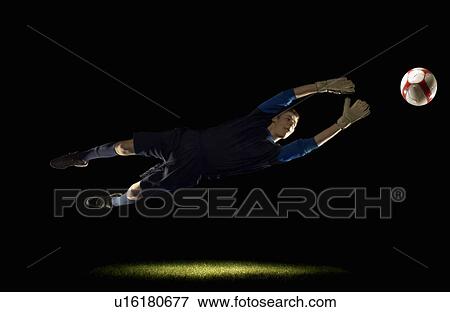 Stock Photo - Goalkeeper diving for ball. Fotosearch