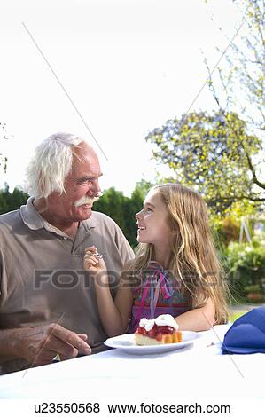 Stock Photo - Granddaughter joking with grandfather. Fotosearch