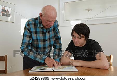 Stock Photography - Grandfather showing map to grandson. Fotosearch