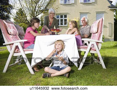 Stock Image - Grandmother serve strawberry pie. Fotosearch