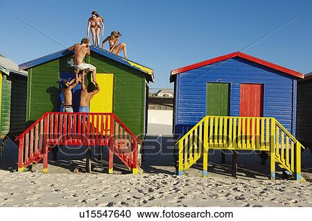Group climbing up on top of beach hut View Large Photo Image Stock Image - Group climbing up on top of beach hut. Fotosearch