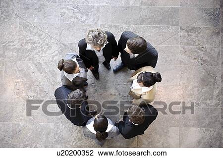 Stock Image - Group of business people forming circle. Fotosearch