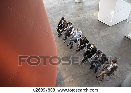 Stock Photo - Group of business people sitting in line. Fotosearch
