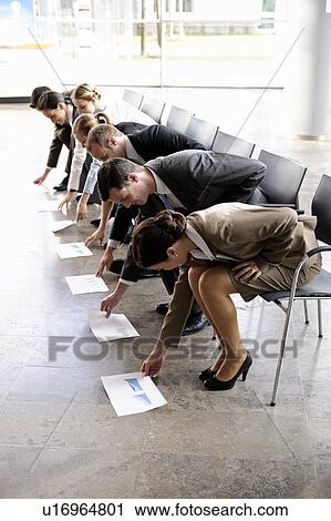 Stock Image - Group of business people with chairs. Fotosearch