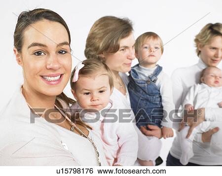 Stock Photograph - Group of mothers with babies. Fotosearch