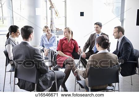 Stock Image - Group of people sitting in circle. Fotosearch