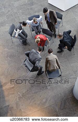 Stock Image - Group of people sitting in circle. Fotosearch
