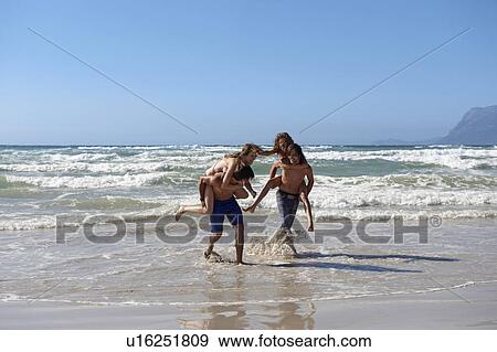 Group playing in surf View Large Photo Image Stock Photo - Group playing in surf. Fotosearch