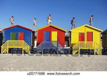 Group running on top of beach huts View Large Photo Image Stock Photograph - Group running on top of beach huts. Fotosearch