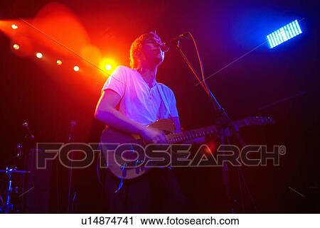 Guitarist singing on stage View Large Photo Image Stock Image - Guitarist singing on stage. Fotosearch