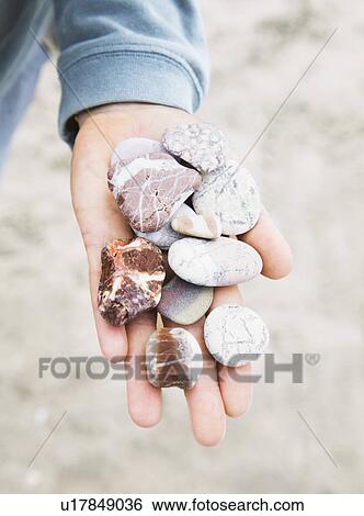 Stock Photograph - Hand with pebbles. Fotosearch