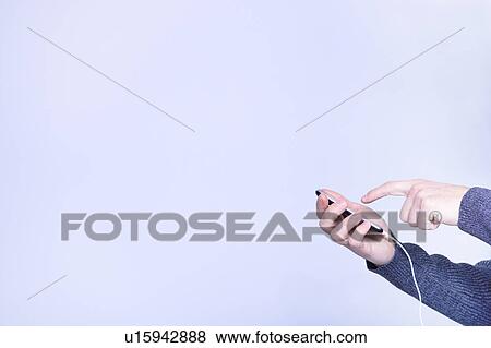 Stock Photo - hands manipulating a smart phone. Fotosearch