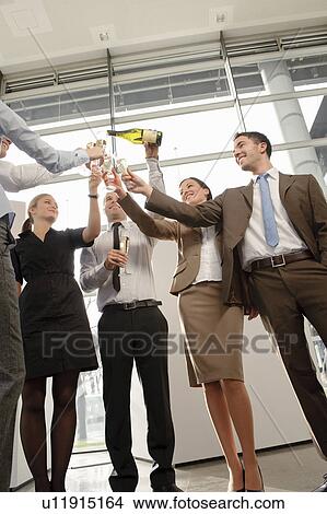 Happy business executives with champagne View Large Photo Image Picture - Happy business executives with champagne. Fotosearch