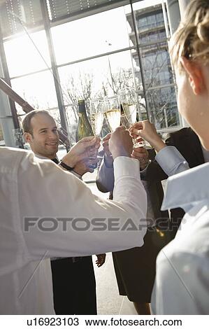 Happy business executives with champagne View Large Photo Image Stock Image - Happy business executives with champagne. Fotosearch