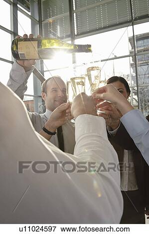Happy business executives with champagne View Large Photo Image Stock Photo - Happy business executives with champagne. Fotosearch