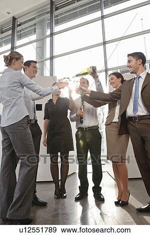Happy business executives with champagne View Large Photo Image Stock Photo - Happy business executives with champagne. Fotosearch