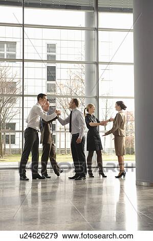Stock Photo - Happy business executives with champagne. Fotosearch