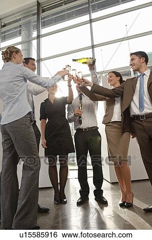 Happy business executives with champagne View Large Photo Image Stock Photograph - Happy business executives with champagne. Fotosearch