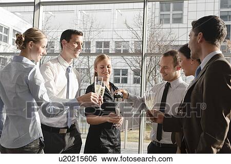 Happy business executives with champagne View Large Photo Image Stock Photograph - Happy business executives with champagne. Fotosearch