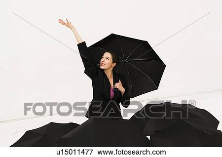 Happy women with umbrella feels for rain View Large Photo Image Stock Photo - Happy women with umbrella feels for rain. Fotosearch