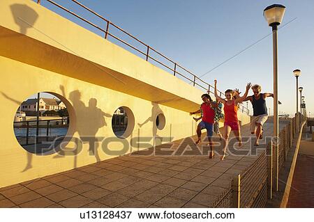 Happy young people leaping View Large Photo Image Stock Photo - Happy young people leaping. Fotosearch