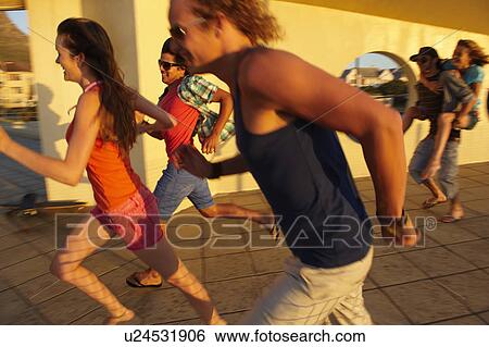 Stock Photograph - Happy young people running. Fotosearch