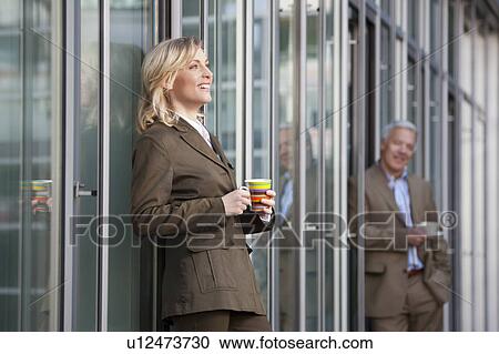 Stock Image - Having a coffee break outside the office. Fotosearch