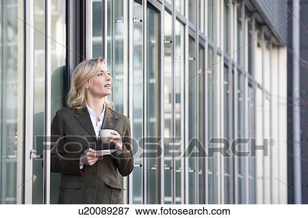 Stock Photo - Having a coffee break outside the office. Fotosearch