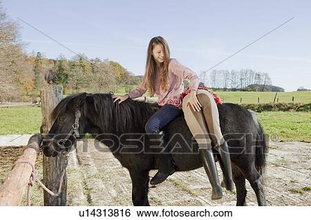 Helping a friend on a horseback View Large Photo Image Stock Photograph - Helping a friend on a horseback. Fotosearch