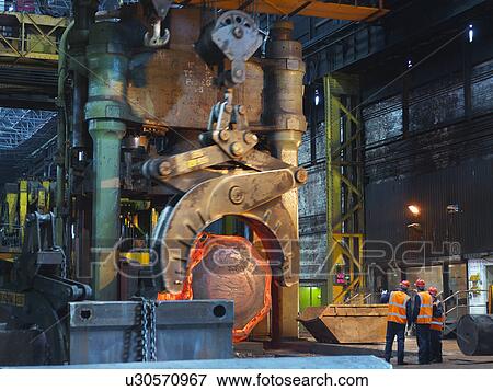 Hot Steel Moving Into Forging Machine View Large Photo Image Stock Photo - Hot Steel Moving Into Forging Machine. Fotosearch