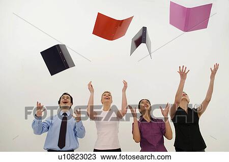 Jubilant business people throw folders View Large Photo Image Stock Image - Jubilant business people throw folders. Fotosearch