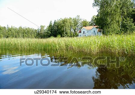 Lake in front of a house View Large Photo Image Picture - Lake in front of a house. Fotosearch