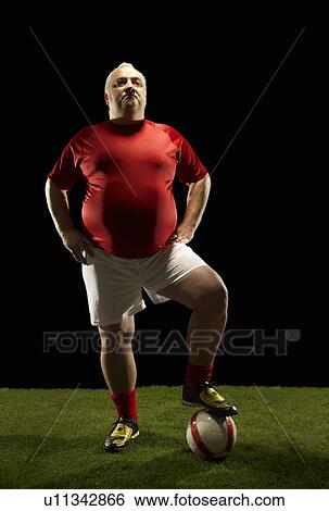 Large sportsman with foot on football View Large Photo Image Stock Photograph - Large sportsman with foot on football. Fotosearch